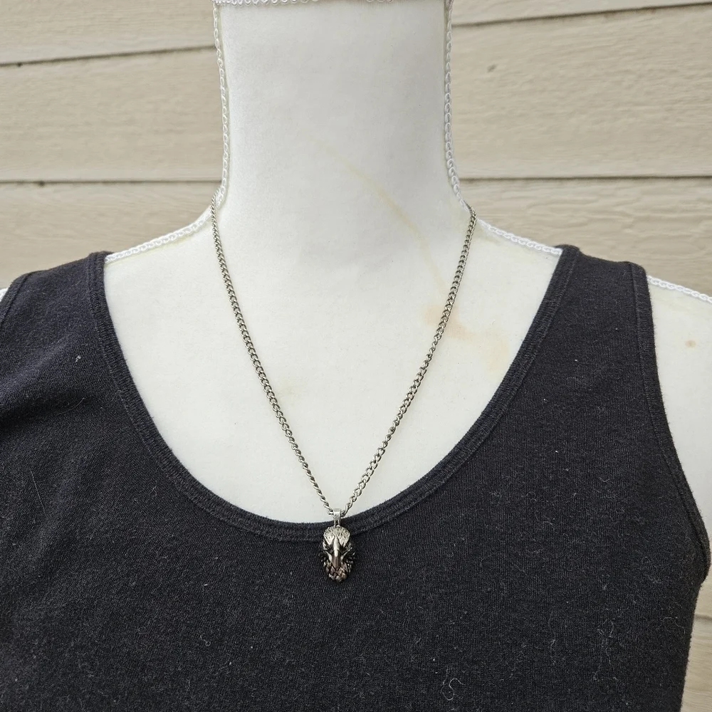 silver tone chain with eagle head pendant